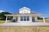 NEUBAU - ERSTBEZUG! Schwedenhaus mit Südbalkon & großem Grundstück in Garlstorf (Bleckede) - Gartenansicht